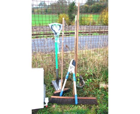 A large soft broom head 30", a lawn rake, an extendable lopper and dirt buddy.