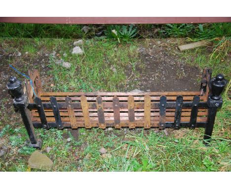 A large fire/dog grate, 30" wide x 14" high x 10 1/2" depth.