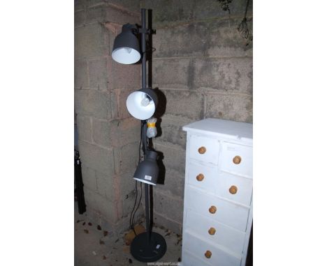 A floor standing industrial style lamp with metal shades.
