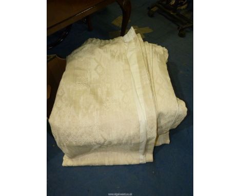 A pair of cream curtains by Dunelm, 70'' drop x 68'' wide.