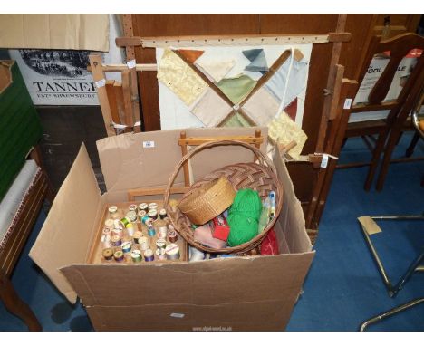 A large box of sewing equipment and tapestry frames.
