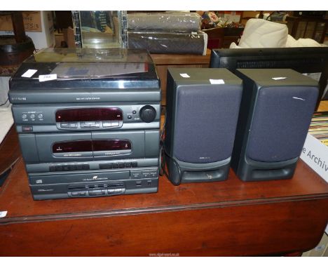 A 'Samsung' CD changer music centre with record deck, cassettes and CDs with remote.