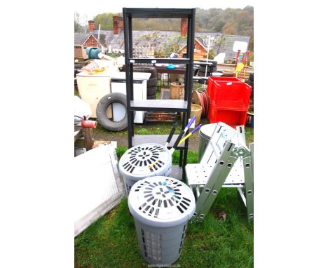 Two plastic linen bins, mops etc and a plastic shelf unit with five shelves.
