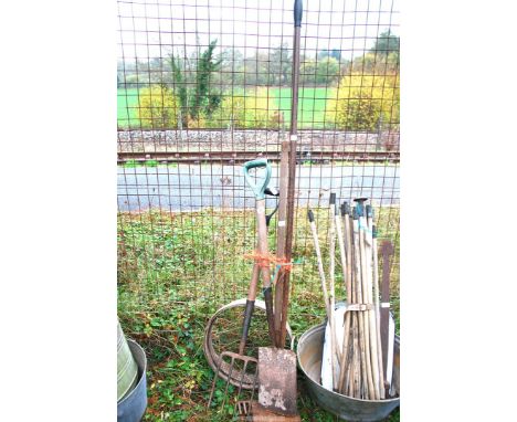 A quantity of garden tools to include: forks, spades, riddle, rake, etc.