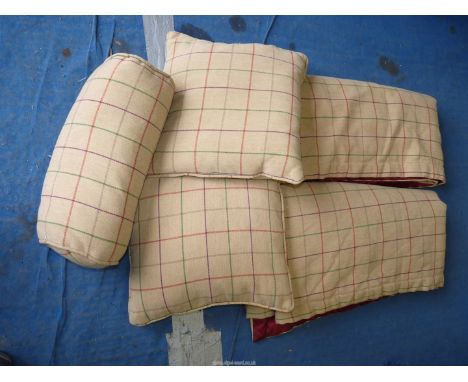 A quantity of sofa cushions and throws.