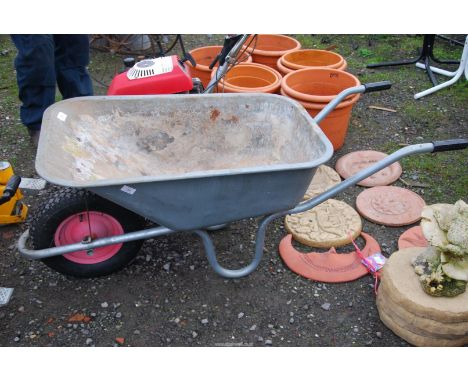 A galvanized wheel barrow on pneumatic tyre.