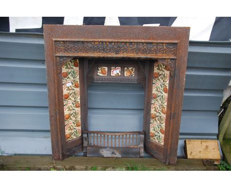 A cast iron fire grate having tiles to the side and tops, 3' wide x 38" high.