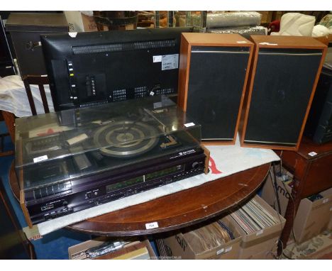 A "Waltham" stereo cassette, and record player with large pod speakers.