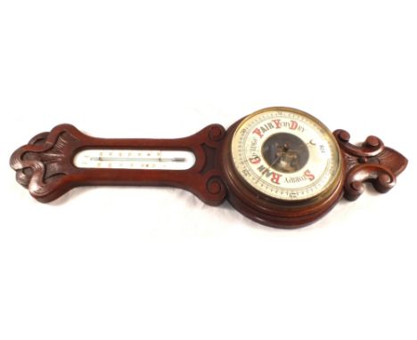 A wall hanging Oak cased barometer with enamel dial
