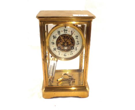 A Brass four glass striking mantel clock