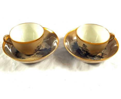 A pair of 19th Century brown pottery bat printed cups and saucers