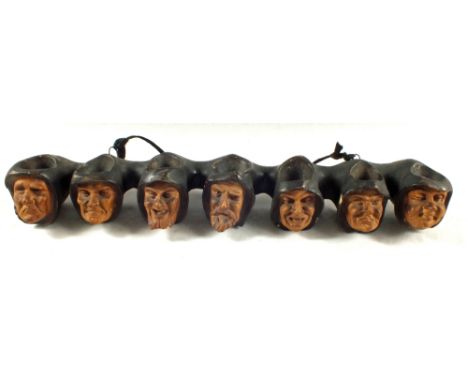 A plaster monks head pipe rack plus a pair of pottery cats