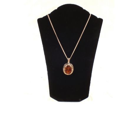 To be sold with no BP, all proceeds to E.A.C.H. A Silver mounted Amber pendant on a Silver chain