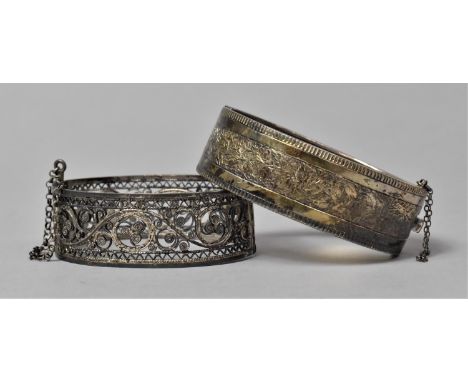 A Silver Bangle with Engraved Decoration and a White Metal Filigree Example 