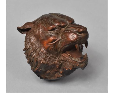 A Carved Wooden Netsuke in the Form of a Snarling Tiger, 5cm high 