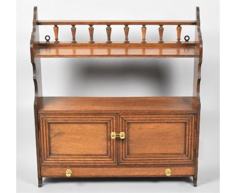 An Edwardian Oak Wall Hanging Shelf Unit with Base Drawer and Cupboard, Raised Spindled Gallery, 57cm wide 