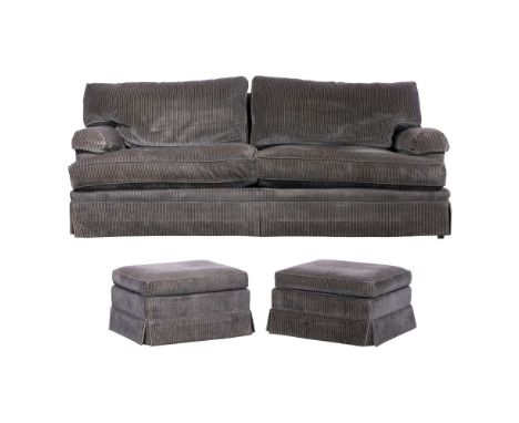 Baker Upholstered Furniture Suite  Including a sofa and a pair of ottomans on casters, all retain Baker Furniture labels  Pro