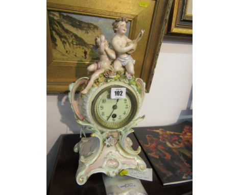 THURINGIAN FLORAL ENCRUSTED MANTLE CLOCK, with amorini cresting (some damage)
