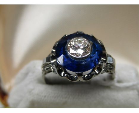 18ct WHITE GOLD SAPPHIRE AND DIAMOND RING,  0.75 carat old brilliant cut Diamond bezel set in to a large single sapphire.  si