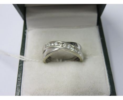 9ct WHITE GOLD DIAMOND CROSS OVER ETERNITY RING, set with approx 0.25ct diamonds, size K