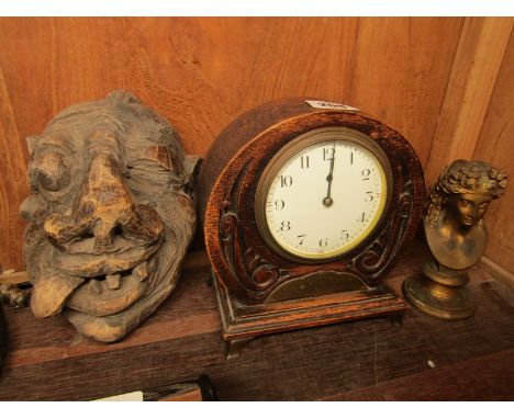 MANTEL CLOCK, carved oak surround mantel clock with presentation plaque; also carved wooden demon head and gilt metal pedesta