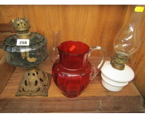 OIL LAMPS, Edwardian cast iron based oil lamp, 1 other and cranberry glass jug 