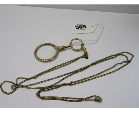 YELLOW METAL QUIZZING GLASS, on yellow metal long guard chain