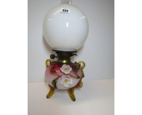 VICTORIAN OIL LAMP, a coloured glass floral applied reservoir oil lamp with spherical milk glass shade