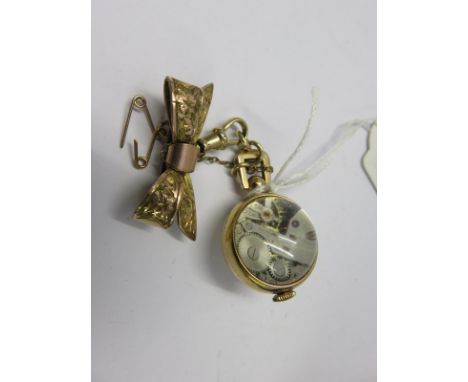 FOB WATCH;  A gold plated console fob watch with crystal back on plated bow clasp with safety chain appears in working condit