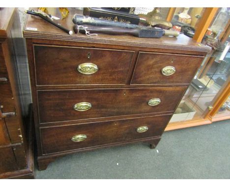 GEORGIAN NARROW MAHOGANY CHEST, 2 short, 2 long graduated drawers with embossed oval brass handles and bracket feet, 34" heig