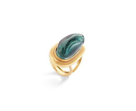 Burle Marx for Kim Poor: A green tourmaline ring The elongated oval fantasy-cut green tourmaline, within a tiered collect set
