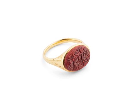  An antique carnelian chalcedony cameo ring  The oval carnelian intaglio, carved to depict a Dutch schuttersstuk scene, colle