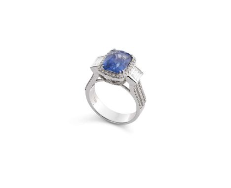  A cushion-shaped sapphire and diamond dress ring  The cushion-shaped sapphire, within a brilliant-cut diamond halo surround,