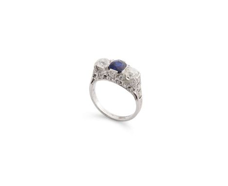  An early 20th century sapphire and diamond ring  Centrally-set with a cushion-shaped sapphire, between old brilliant-cut dia