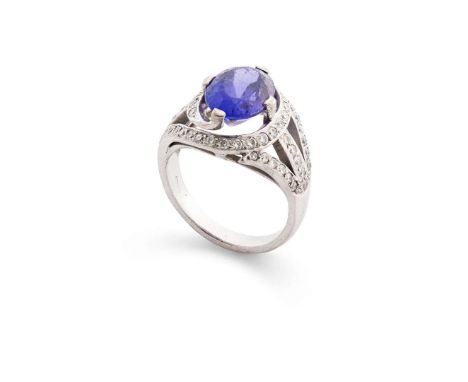  A tanzanite, diamond and white gold dress ring  Claw-set with an oval-cut tanzanite in an open border set with brilliant-cut