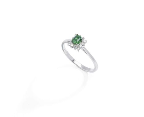  A demantoid garnet and diamond cluster ring, 1978  Centrally set with a square step-cut demantoid garnet, in a four-claw set