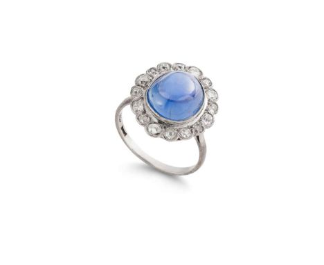  A sapphire and diamond cluster ring, first half of the 20th century  The oval cabochon sapphire, within a cushion-shaped dia