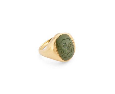  A green hardstone intaglio signet ring  Engraved with the crest of a lion rampant above a coronet, the reverse carved with h