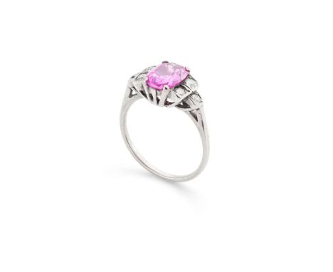  A pink sapphire and diamond ring  The cushion-shaped pink sapphire, in a four-claw setting, between trios of old brilliant-c
