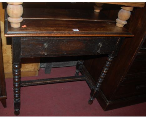 An early 20th century oak single drawer side table, raised on bobbin turned supports, w.76cm 