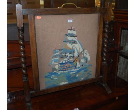 An early 20th century barleytwist oak tapestry embroidered fire screen