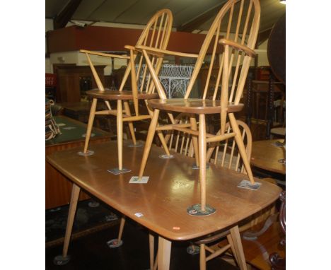 An Ercol light elm dining table, together with a set of six Ercol light elm stickback dining chairs (4+2)(7)