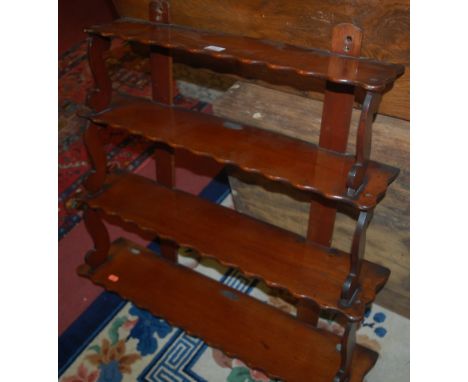 A circa 1900 mahogany four tier waterfall open wall shelf, each tier of wavy form