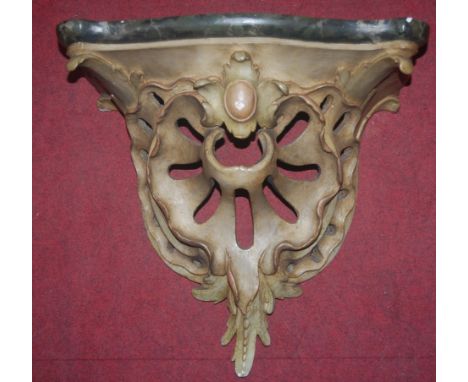 A painted gesso wall bracket of shaped form