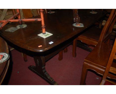 An Ercol dark elm dining table