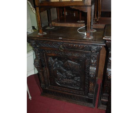 A late 19th century Continental heavily carved oak single door side cupboard, having single long upper drawer, width 92cm Con