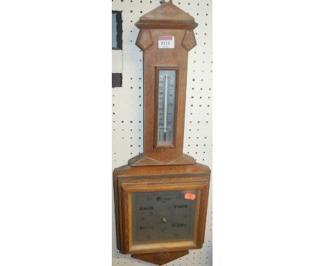 A 1930s limed oak two dial aneroid barometer