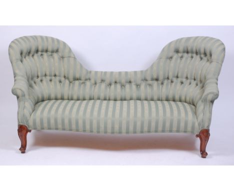 A Victorian walnut framed and green floral striped upholstered double spoonback sofa, having buttonback, and raised on leaf c