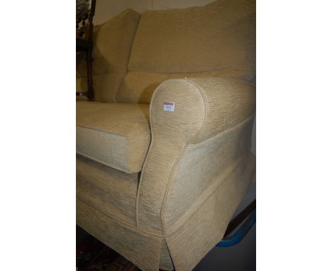 A modern cream upholstered two seater sofa