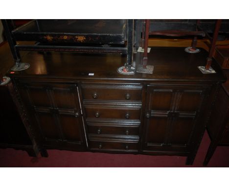 An Ercol dark elm dresser base 